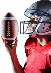 Canvas Print - Sportsman looking up while holding American football