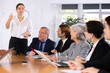 © JackF - Group of diverse business people attending meeting in conference room, discussing work plan