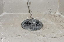 A Water Of Stream Is Pouring On The Shower Drain Grate