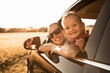 Portrait of happy mother and child in car smiling enjoying summer family holiday road trip 