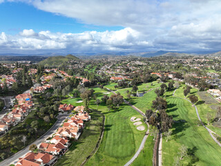 Wall Mural - Aerial view of residential neighborhood surrounded by golf and valley during cloudy day in Rancho Bernardo, San Diego County, California. USA. 