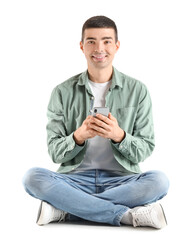 Poster - Young guy with mobile phone sitting on white background