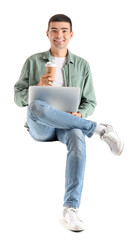 Poster - Young guy with cup of coffee and laptop sitting in chair on white background