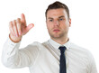 Young serious businessman pointing 