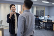 © Blue Jean Images - Cheerful Chinese business people greeting in office