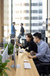 © Blue Jean Images - Chinese business people talking in office