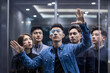 © Blue Jean Images - Confident Chinese designers checking futuristic glasses