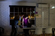 © Wavebreak Media - Diverse business people standing at desk, using laptop and discussing, working late at office