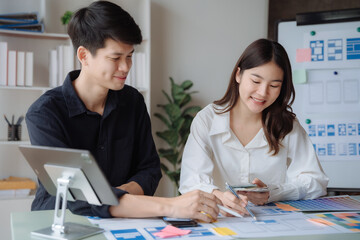 ui designer brainstorming about mobile app interface wireframe design with customer breif and color code at office.