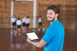Sports teacher using digital tablet