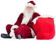 Santa sits next to his bag