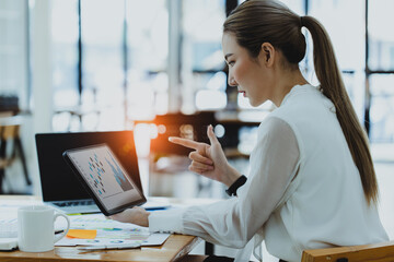 Technology and financial advisory services concert. Business woman working on digital tablet and laptop computer with advisor showing plan of investment to clients at table office. Digital marketing.