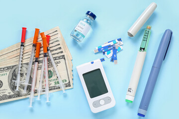 Wall Mural - Insulin with glucometer, lancet pens, syringes and money on blue background. Expensive medicine concept