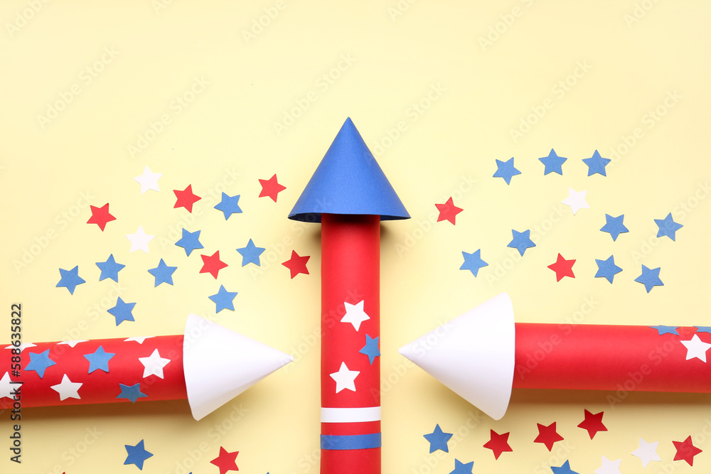 Firework rockets with stars for Independence Day on beige background