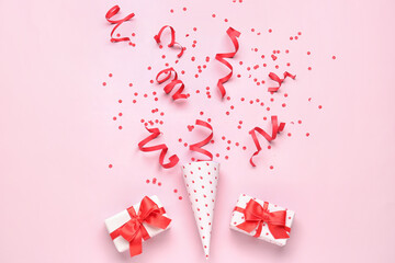 Wall Mural - Party cone with serpentine, confetti and gifts on pink background