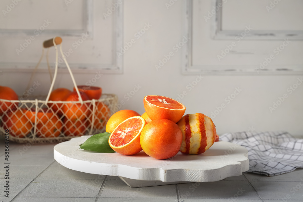 Plate with tasty blood oranges on tile table