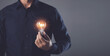 © SKT Studio - Idea for designing new things, Creative design thinking, Using new technology to innovate in the future, hand holding light bulb with light effect. Bright and creativity for work concept.
