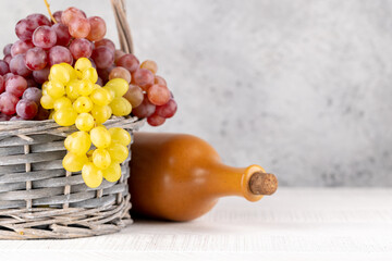 Wall Mural - Ripe grape in basket and wine bottle