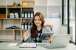© Nuttapong punna - Woman freelancer is working her job on computer tablet and laptop Doing accounting analysis report real estate investment data, Financial