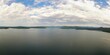 Wide angle drone view of Lake Jocassee surrounded by hills under a cloudy sky in South Carolina, USA