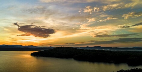 Wall Mural - Wide angle of Lake Jocassee surrounded by hills and forests at sunrise in South Carolina, USA