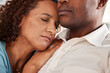 © Malik/peopleimages.com - Love, comfort and couple rest in home for bonding, quality time and relax together in living room. Marriage, relationship and black man and woman sleeping on couch for support, peace and embrace