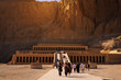 Ancient temple dedicated to Queen Hatshepsut. Visitors going into the temple which is built in the rocks in the desert. Travel concept.
