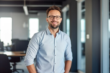 business man with shirt stands casually in modern glass office and smiles at camera - theme success,