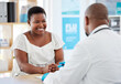 Doctor, black woman and healthcare consultation with a wellness and hospital worker in office. Consulting, patient and happy female with smile from health communication and expert advice in a clinic