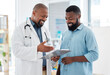 © Nina/peopleimages.com - Healthcare, black man and doctor with clipboard, diagnosis and conversation for results, smile and care. Male patient, guy and medical professional with documents, paperwork for insurance and talking