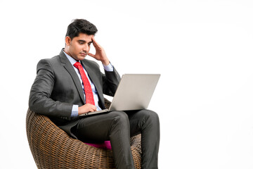 Young indian Businessman in stress while using laptop.