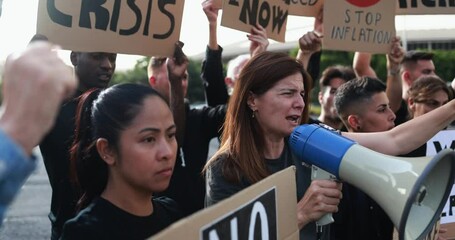 Wall Mural - Group of multiracial people protest against inflation and financial crisis - Protesters marching for rise cost of living in the city - Mature woman screaming with megaphone