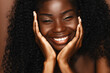 African American model beauty portrait. Brunette curly haired young woman with dark skin and a perfect smile