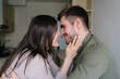 © BullRun - Happy couple looking into eyes in kitchen