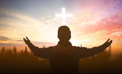 Wall Mural - christian raising hands in praise worship and prayer to god with white cross at sunrise