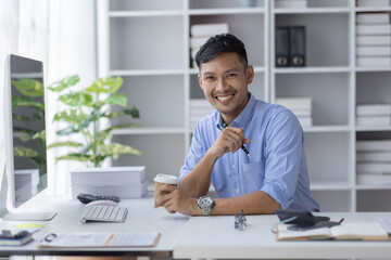 Wall Mural - Portrait of  Asian business man holding coffee cup with work in workplace office  Business documents money financial planning concept