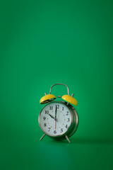 Wall Mural - Retro silver alarm clock. 10:00.  am,  pm. Green background.