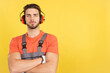 © Iván Moreno - Serious worker standing with arms crossed looking at camera