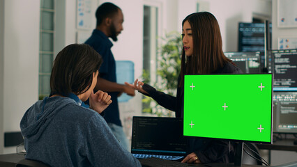 Asian IT engineers analyzing greenscreen on computer and coding database program with html script. Using mockup template with isolated copyspace and chromakey, programming code.