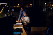 © Wavebreak Media - Diverse business people sitting at desk, using computer for video call, working late at office
