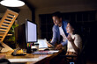 © Wavebreak Media - Diverse happy business people using computer with copy space on screen, working late at office