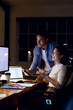 © Wavebreak Media - Diverse happy business people using computer, working late at office, with copy space
