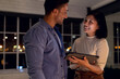 © Wavebreak Media - Diverse happy business people using tablet together and discussing, working late at office
