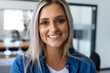 © Wavebreak Media - Portrait of casual happy caucasian businesswoman looking at camera in modern office
