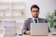 © Elnur - Young male employee and too much work in the office