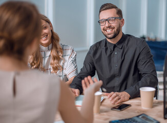 Poster - business team discussing business issues over a Cup of coffee