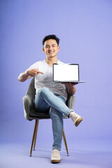 Wall Mural - image of asian boy posing on purple background