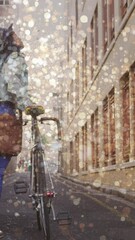 Sticker - Animation of light spots over biracial woman walking with bicycle