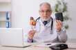 © Elnur - Old male doctor cardiologist working in the clinic
