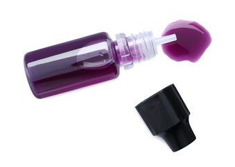 Wall Mural - Bottle of purple food coloring on white background, top view